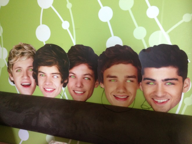 Scary One Direction masks that line Sakina's bed